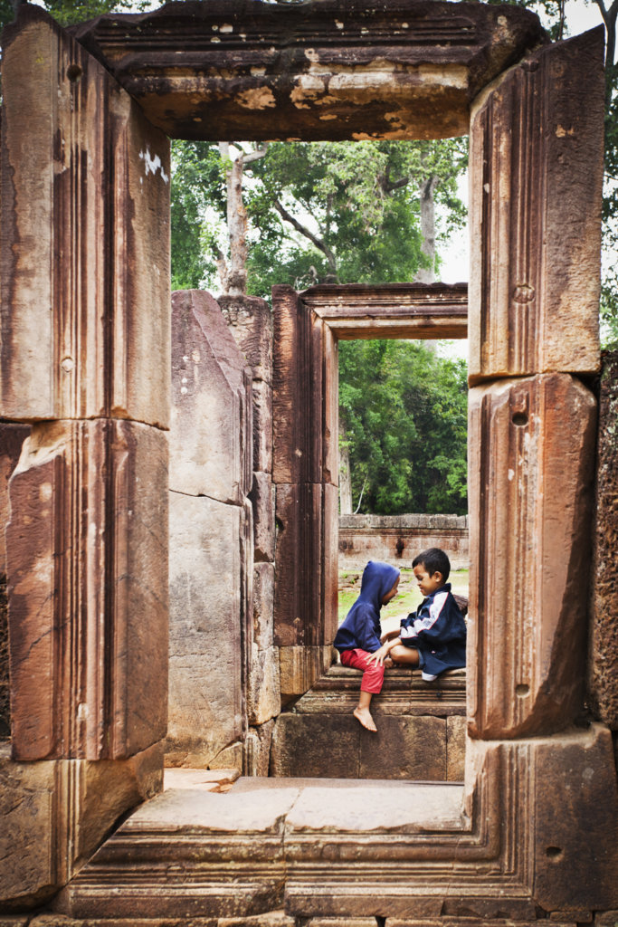 Local kids playing in a window frame, Banteay Srei