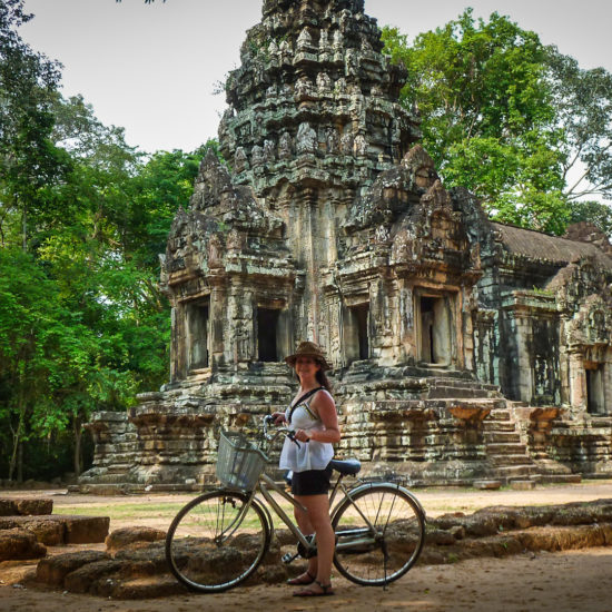 Riding bikes past Thommanon temple near Angkor Thom